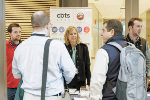 CBTS team talking with a couple attendees