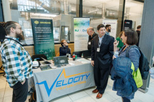 Velocity team talking to attendee