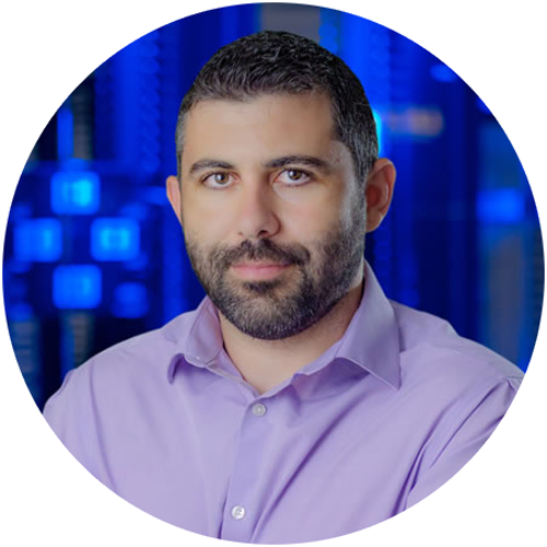 Adam-arms-crossed-blue-background-Circle-500x500