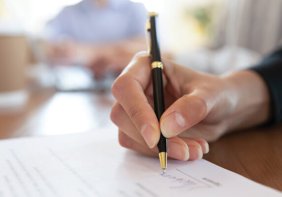 VFTE-LeveragingGrant-600x400 Writing signature on legal paperwork.